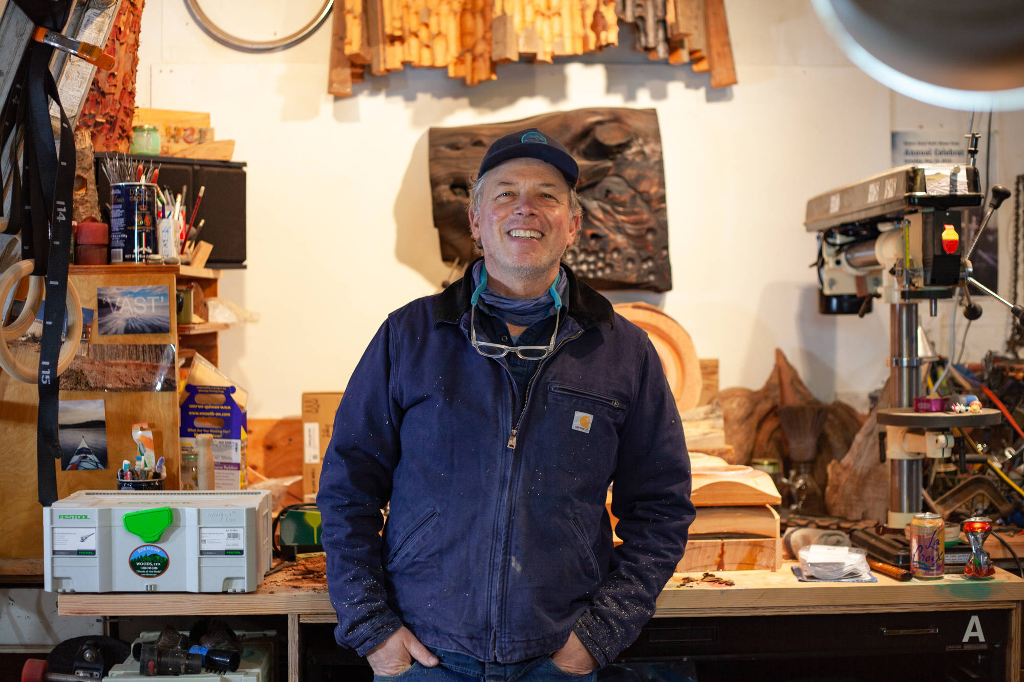 Andy McConnell, woodworking visual artist in West Seattle, WA standing on a ledge